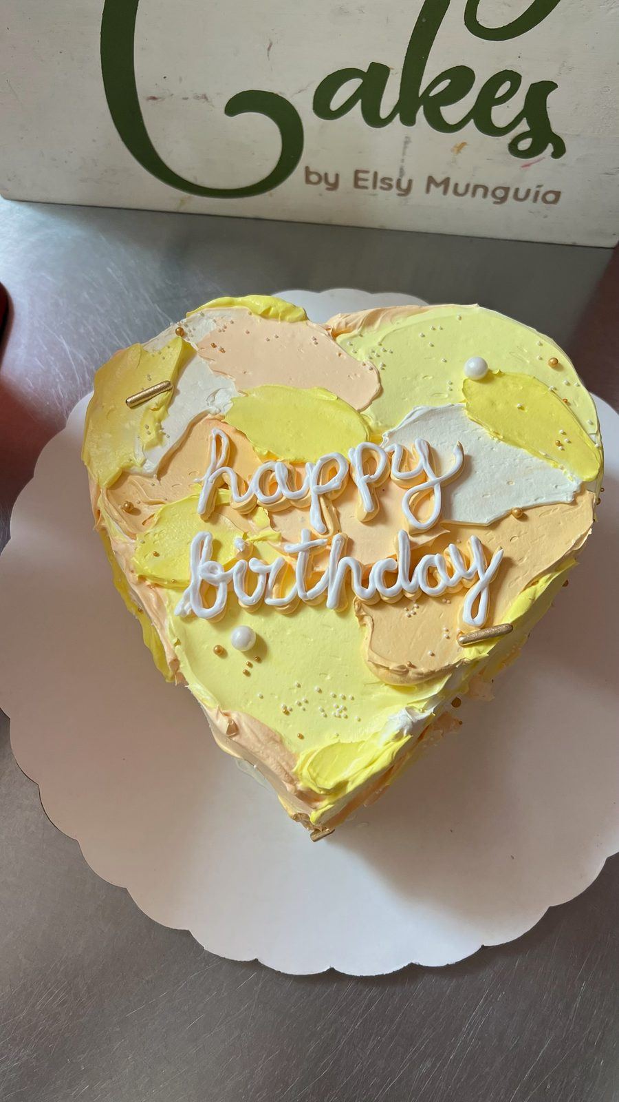 Yellow heart-shaped birthday cake