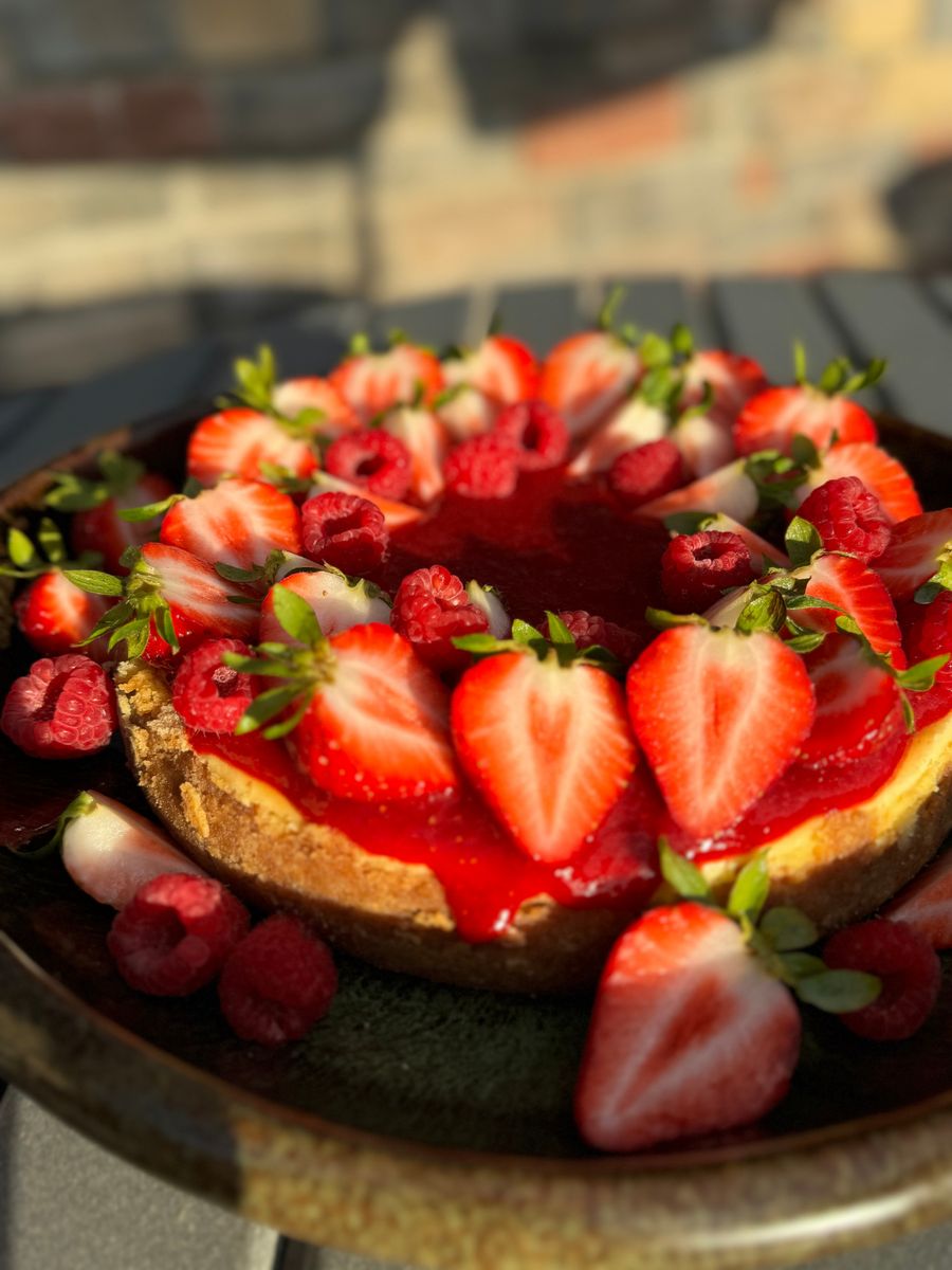 Cheesecake topped with strawberries and raspberries