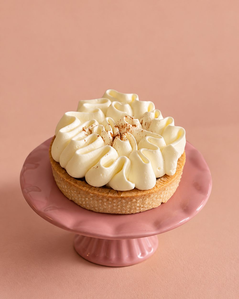 Apple tart with whipped cream and cinnamon