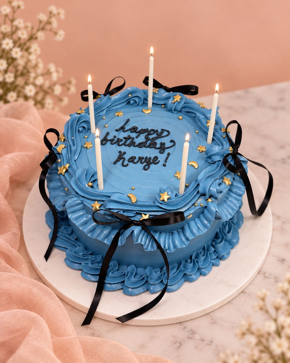 Blue cake with black ribbon bows