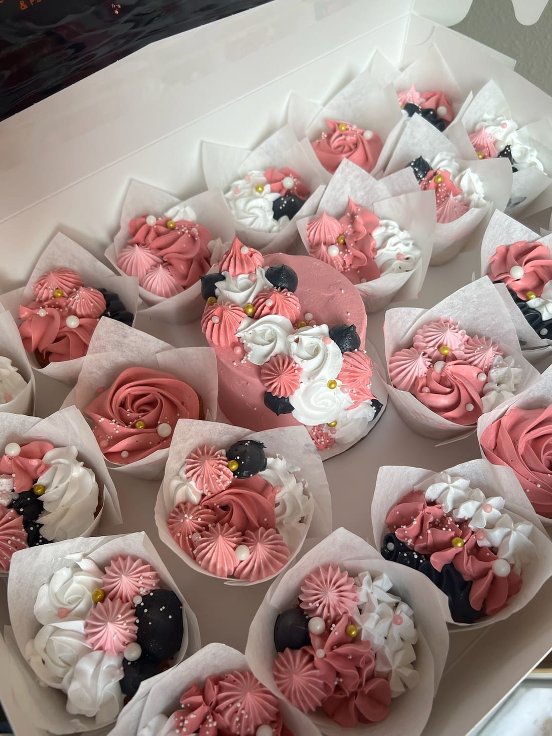 Box of pink and white rosette cupcakes